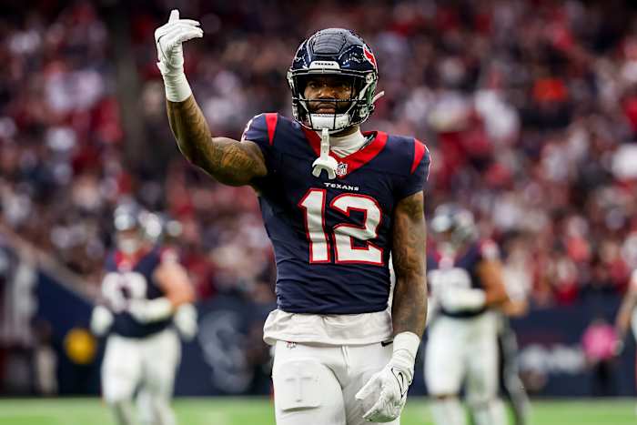 Texans wide receiver Nico Collins (12) celebrates catching the ball during the first quarter in a 2024 AFC wild card game at NRG Stadium.